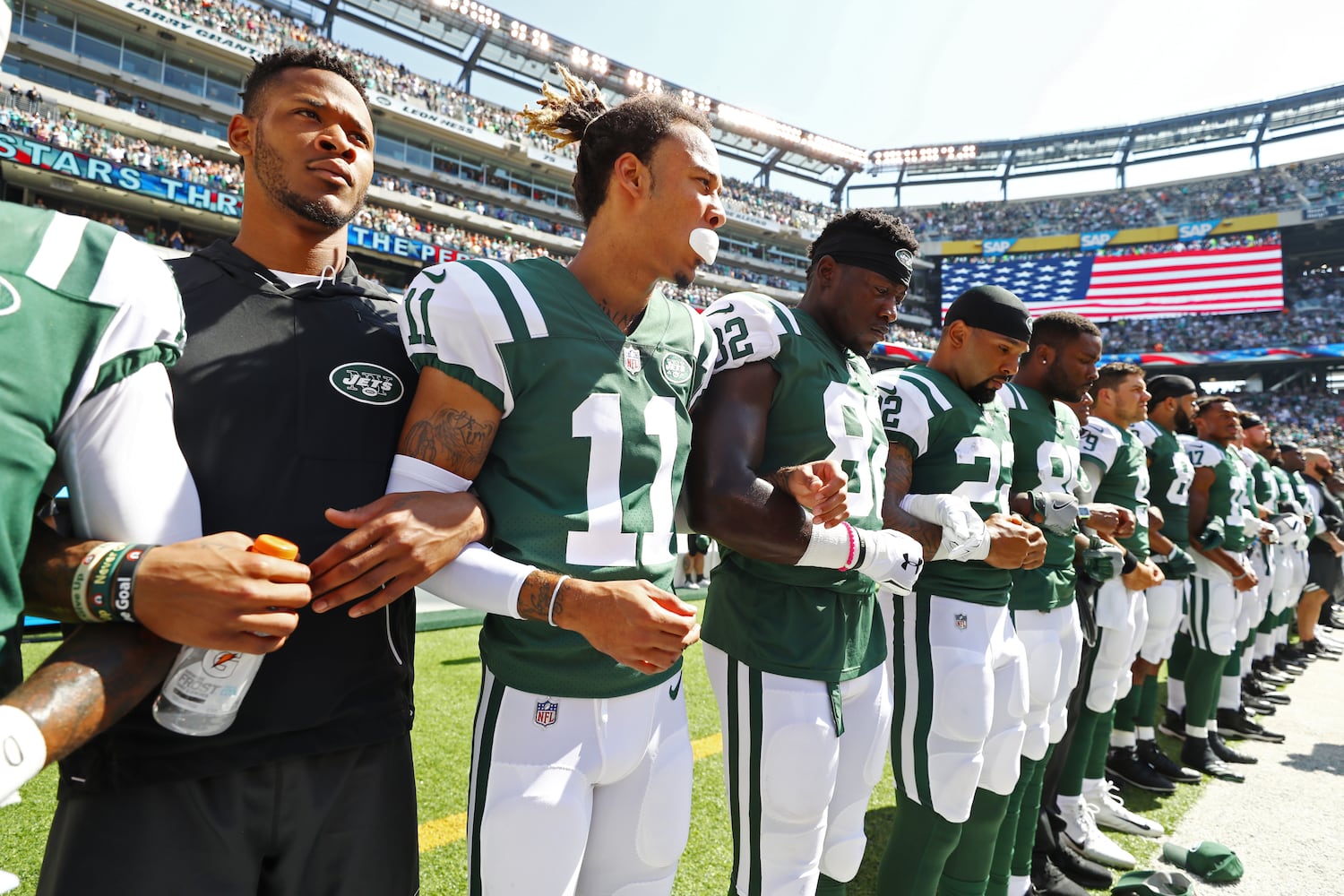 Photos: Falcons show solidarity during National Anthem