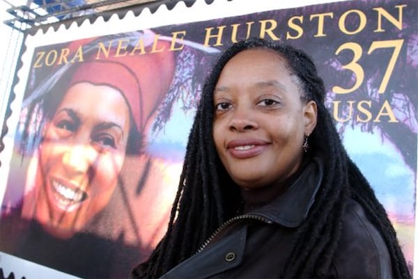 Valerie Boyd poses in front of the Zora Neale Hurston U.S. Postal Service Stamp. Courtesy of Phelan M. Ebenhack