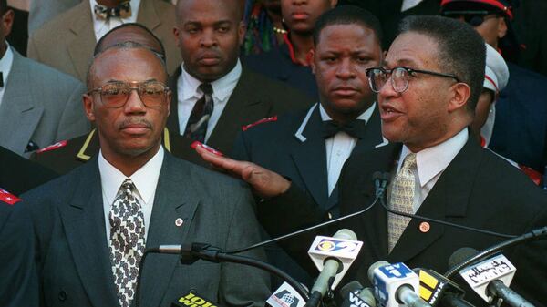 Alleged Malcolm X assassin Muhammad Abdul Aziz, left, is introduced by Minister Benjamin Muhammad, right, in March 1998 as the new head of Harlem's Muhammad Mosque No. 7 in Harlem, where Malcolm preached in the 1950s. A recently released Netflix documentary on the 1965 assassination has prompted the Manhattan district attorney to open a review of the case. The documentary theorizes that two of the three men convicted in the case — including Aziz — were innocent.