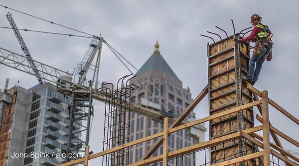 A light fog hovered over the Spectrum apartment building in the 1200 block of Spring Street early Thursday. JOHN SPINK / JSPINK@AJC.COM