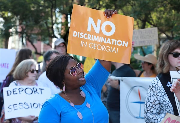 August 9, 2018, Macon: Stacy Jenkins joins several dozen protesters gathered across the street from the United Sates Attorney's Office for the Middle District of Georgia during a visit by Attorney General Jeff Sessions on Thursday, August 9, 2018, in Macon.  Curtis Compton/ccompton@ajc.com