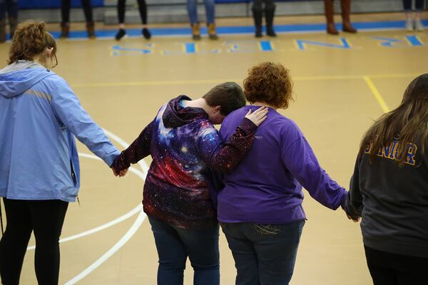 Local resident Wanda Dotson is consoled by her daughter Kaitlyn as students, teachers and locals hold a prayer circle in the gymnasium of Beauregard High School for those in their community that lost their lives in a F-3 tornado on Monday, March 4, 2019, in Beauregard. Twenty-three people -- including a six-year-old -- were killed by a storm Sunday, though that number is expected to climb, Lee County Sheriff Jay Jones told reporters Monday morning. The destruction area is at least a half a mile wide and at least a mile long, he added.     Curtis Compton/ccompton@ajc.com