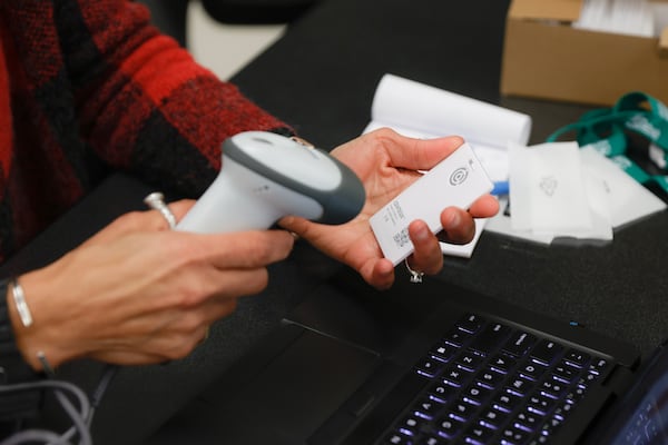 A Findley Oaks Elementary faculty member adds Centegix crisis alert badges to the school’s system during a faculty training on Monday, March 20, 2023.  (Natrice Miller/ natrice.miller@ajc.com)