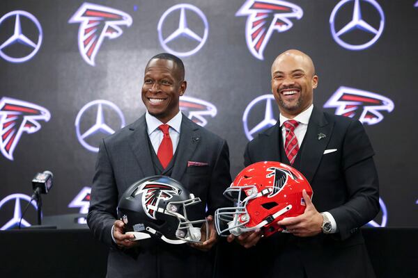 Atlanta Falcons new head football coach Raheem Morris poses with an Atlanta Falcons helmet next to General Manager Terry Fontenot at Mercedes-Benz Stadium, Monday, February 5, 2024, in Atlanta. (Jason Getz / Jason.Getz@ajc.com)