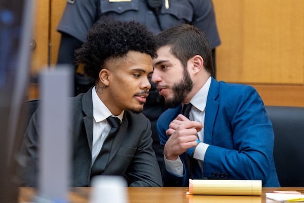 Attorney Anastasios Manettas speaks to his client Miles Farley at hearing on the YSL case in Atlanta on Thursday, December 22, 2022. (Arvin Temkar / arvin.temkar@ajc.com)