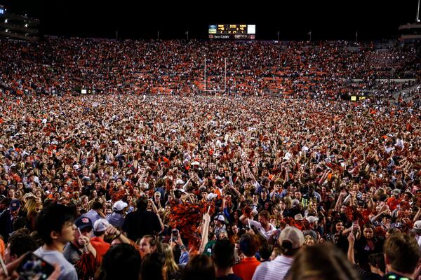 Auburn fans storm the field after their team defeated Alabama 48-45 in an NCAA college football game Saturday, Nov. 30, 2019, in Auburn, Ala. (AP Photo/Butch Dill)