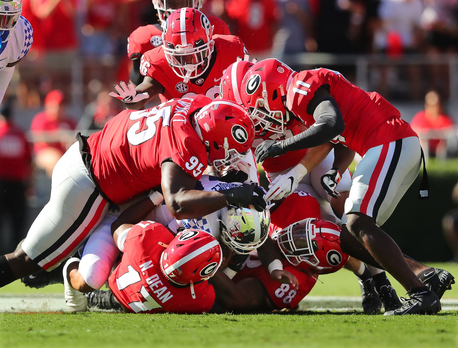 Georgia defenders smother Kentucky running back Chris Rodriguez Jr. to bring up third down and 16 yards during the first quarter Saturday, Oct. 16, 2021, in Athens. Georgia beat Kentucky 30-13.   (Curtis Compton / Curtis.Compton@ajc.com)