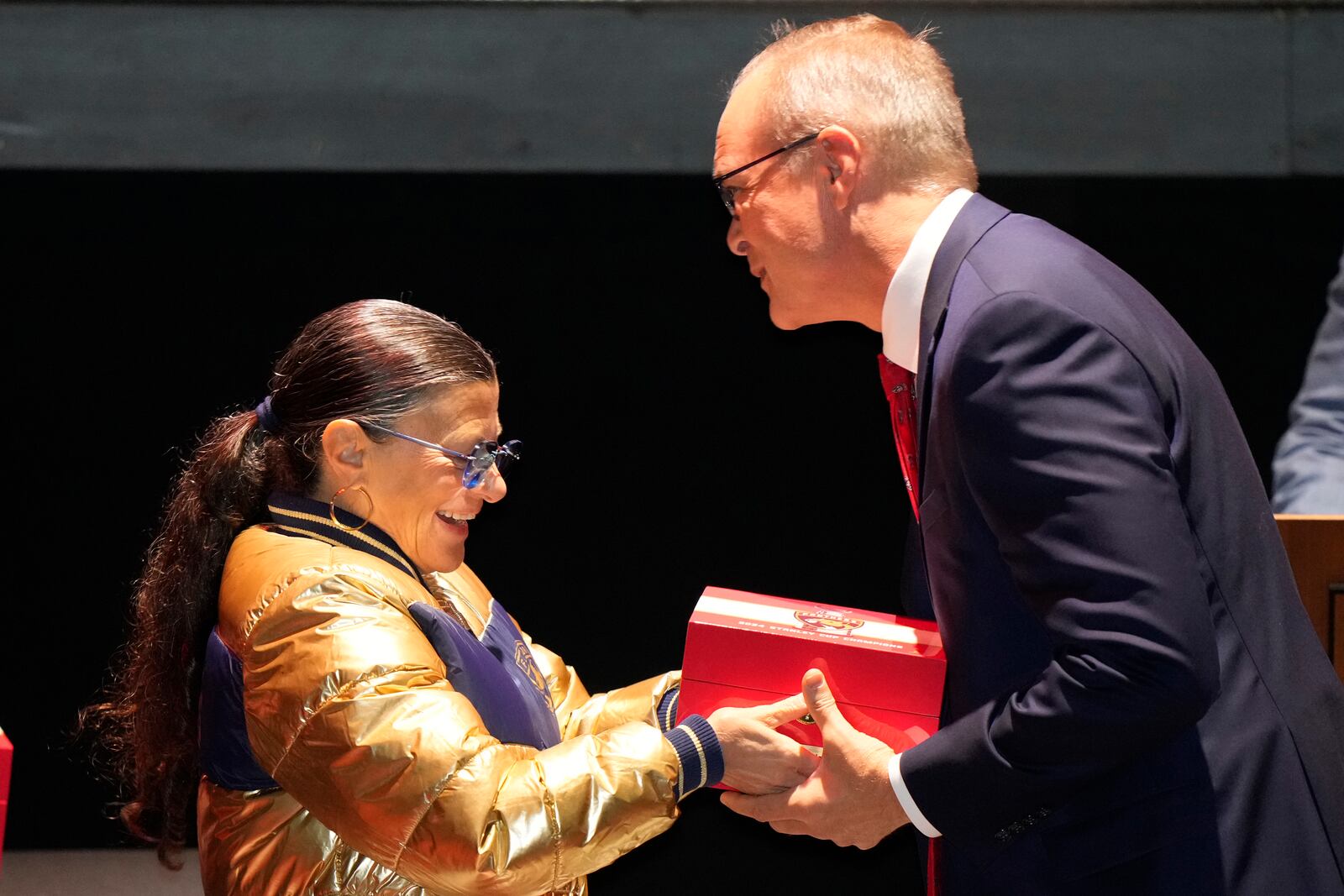 Florida Panthers head coach coach Paul Maurice, right, receives his Stanley Cup championship ring from Teresa Viola, wife of owner Vincent Viola, during a private ceremony commemorating the NHL team's Stanley Cup title last season, Monday, Oct. 7, 2024, in Fort Lauderdale, Fla. (AP Photo/Wilfredo Lee)