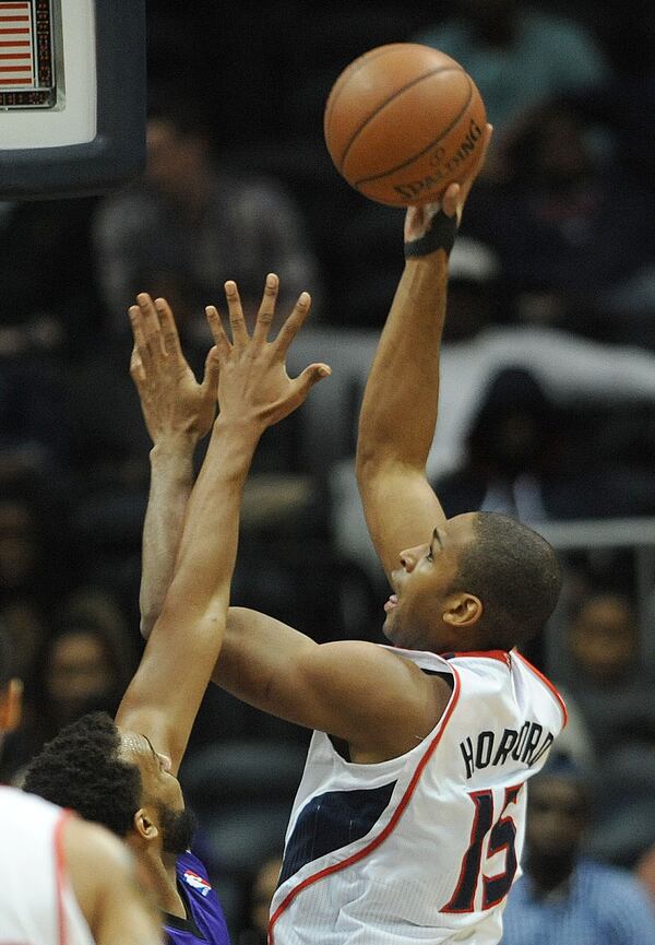 December 18, 2013 - Atlanta: Atlanta Hawks Al Horford (15) shoots the basketball over the hands of a Sacramento Kings player on Wednesday, December 18, 2013, in Philips Arena. The Hawks won the game 124 to 107 and Horford had 25 points. JOHNNY CRAWFORD / JCRAWFORD@AJC.COM Al Horford is returning from a torn right pectoral muscle that limited him to 29 games last season. (AJC File)