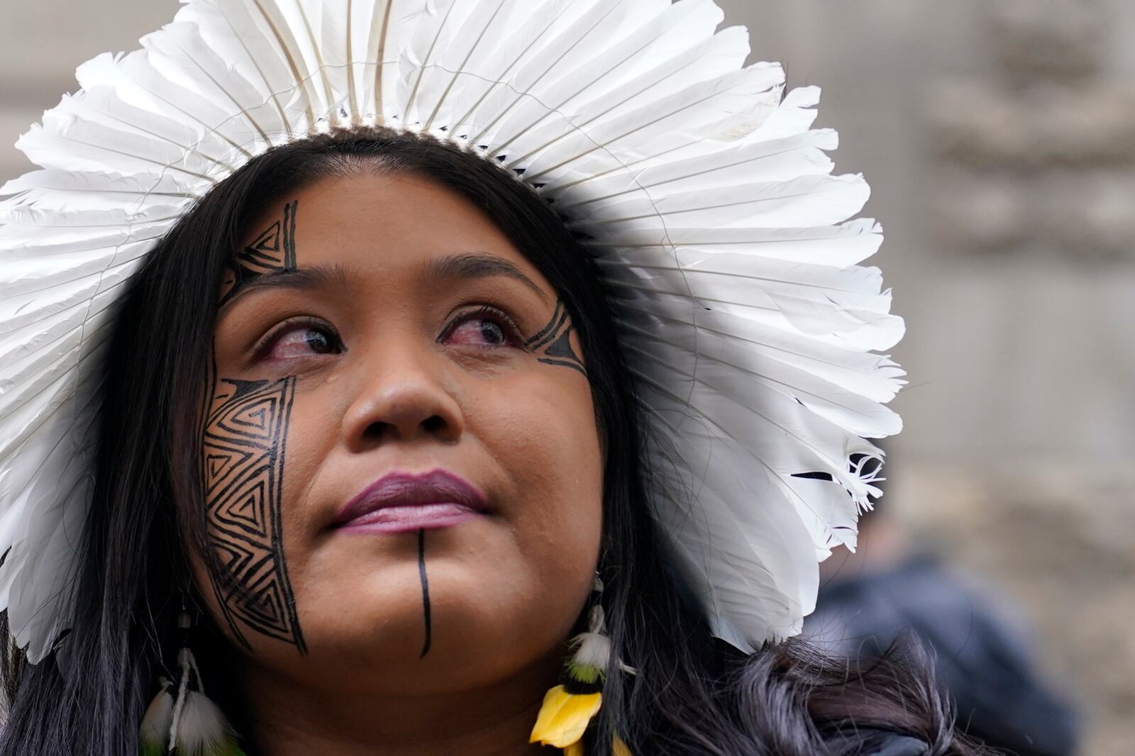 Wakrewa Krenak, from Brazil, stands outside the Royal Courts of Justice in London, Monday, Oct. 21, 2024, as lawyers representing around 620,000 Brazilians as well as businesses, municipal governments, and members of the Krenak indigenous tribe are bringing a multibillion-pound legal action against BHP Group following the collapse of the Fundao dam in November 2015. (AP Photo/Alberto Pezzali)