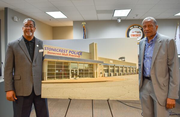 Stonecrest Mayor Jason Lary (left) and Councilman Jimmy Clanton pose with a rendering of the old Sears facility that could become a new public safety complex.