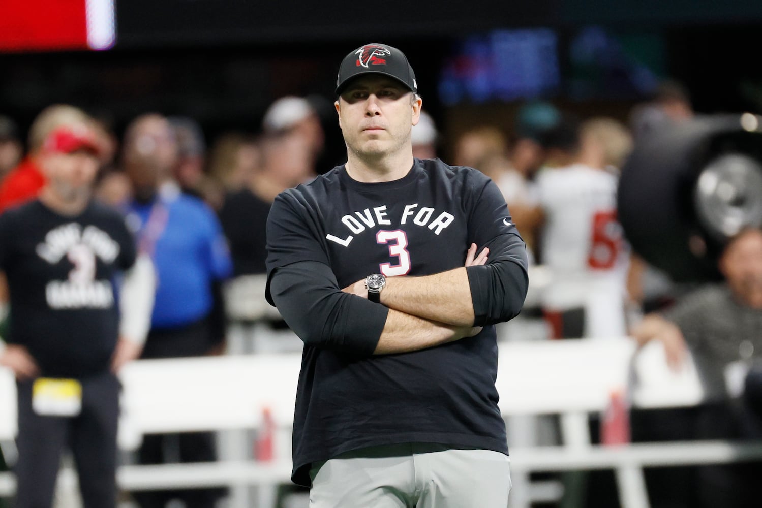 Falcons coach Arthur Smith watches his team during warmups Sunday wearing a T-shirt supporting Bills safety Damar Hamlin. (Miguel Martinez / miguel.martinezjimenez@ajc.com)