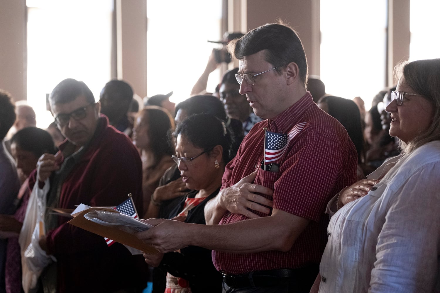 New U.S. citizens say the Pledge Of Allegiance during a Naturalization ceremony at Jimmy Carter National Historic Park in Plains on Tuesday, Oct. 1, 2024. The ceremony was held in honor of President Carter’s 100th birthday.  Ben Gray for the Atlanta Journal-Constitution