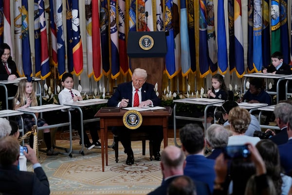 President Donald Trump signs an executive order in the East Room of the White House in Washington, Thursday, March 20, 2025.(AP Photo/Jose Luis Magana)