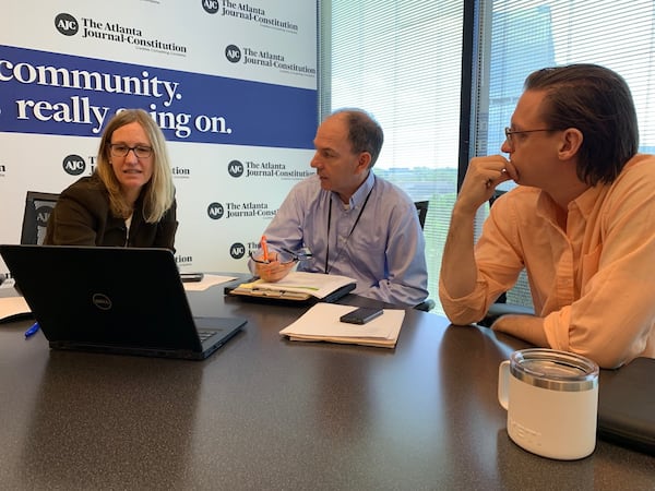 AJC investigative reporters Carrie Teegardin (left), Brad Schrade and data specialist Nick Thieme discuss the "Unprotected" project in this 2019 photo.