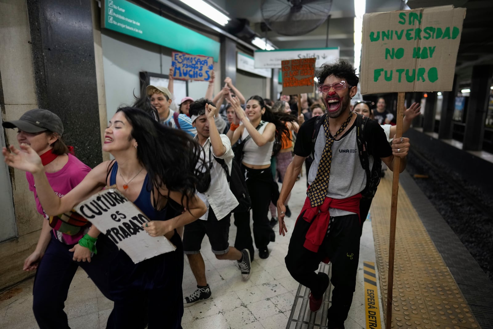 Students exit the subway on their way to a rally outside Congress to protest President Javier Milei's veto of a law to increase funding for public universities in Buenos Aires, Argentina, Wednesday, Oct. 9, 2024. (AP Photo/Rodrigo Abd)