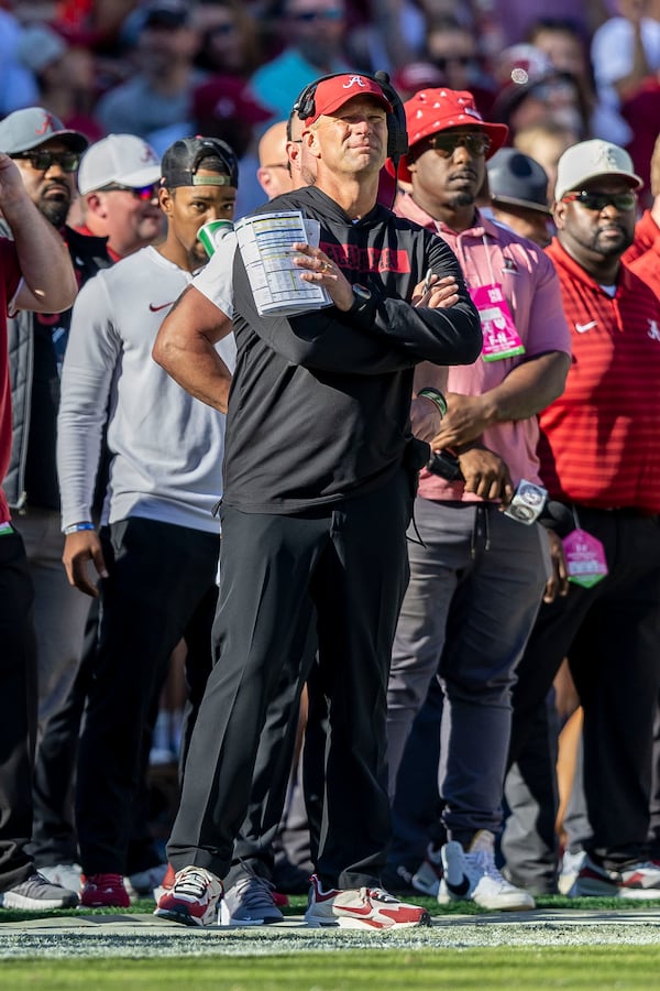 Alabama head coach Kalen DeBoer, center, looks on as his team builds a comfortable lead during the first half of an NCAA college football game against Mercer, Saturday, Nov. 16, 2024, in Tuscaloosa, Ala. (AP Photo/Vasha Hunt)