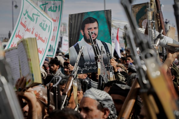 Houthi supporters chant slogans and hold pictures of Abdul Malik al-Houthi, the leader of the Houthi movement, during an anti-U.S. and anti-Israel rally in Sanaa, Yemen, Monday, March 17, 2025. (AP Photo/Osamah Abdulrahman)