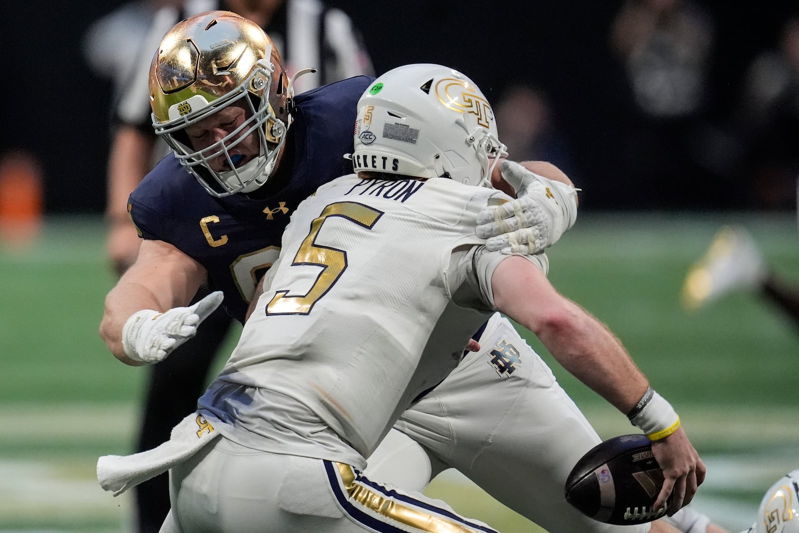 Notre Dame defensive lineman Rylie Mills (99) hits Georgia Tech quarterback Zach Pyron (5) during the second half of an NCAA college football game, Saturday, Oct. 19, 2024, in Atlanta. (AP Photo/Mike Stewart)