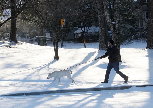    An early morning dog walker along Freedom Parkway.  Gov. Deal declared a state of emergency in 83 Georgia counties for Wednesday, Jan. 17.  BOB ANDRES  /BANDRES@AJC.COM