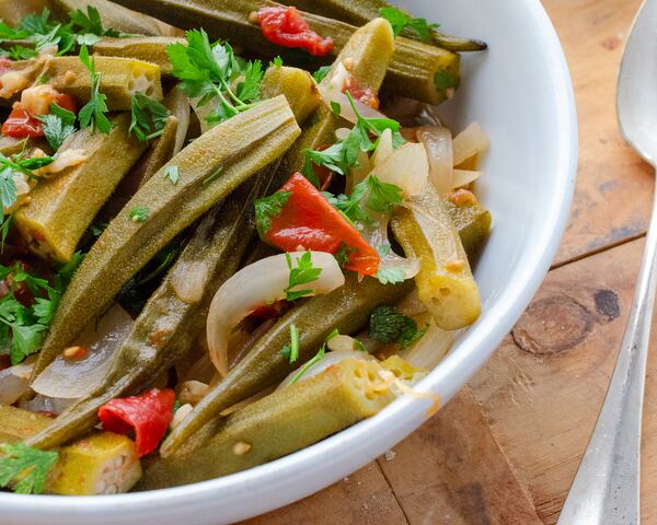 Due to their acidity, tomatoes and red wine vinegar improve the texture of okra in this flavorful Greek-style dish. (Virginia Willis for The Atlanta Journal-Constitution)