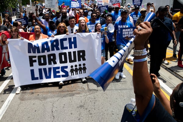 U.S. Reps. Nikema Williams and Lucy McBath hold a banner alongside event organizers during a March for Our Lives on Saturday, June 11, 2022, in Atlanta. The protesters walked from Martin Luther King Jr. National Historical Park to Woodruff Park where a rally was held. (Chris Day / Christopher.Day@ajc.com)