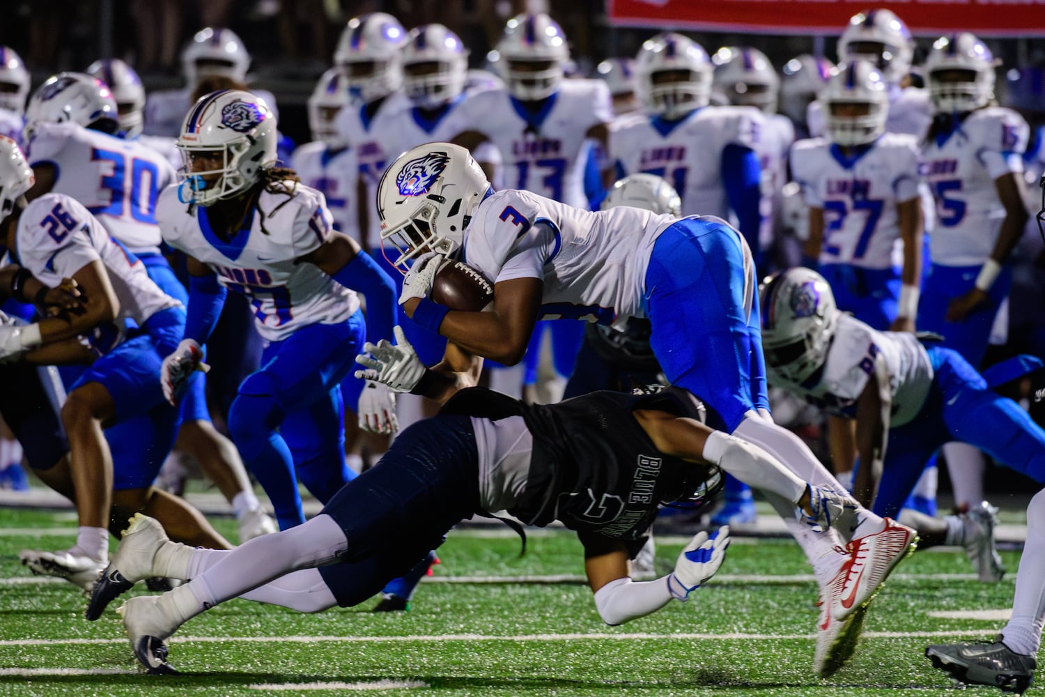 Wide receiver Lamar White is tackled during the Peachtree Ridge at Norcross football game, October 27, 2023. (Jamie Spaar for the Atlanta Journal Constitution)