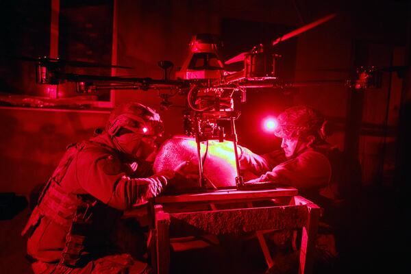 Servicemen of Ukraine's Khartia brigade pack a Vampire drone with food and water to launch toward the frontline to Ukrainian positions near Kharkiv, Ukraine, late Thursday, Nov. 7, 2024. (AP Photo/Efrem Lukatsky)