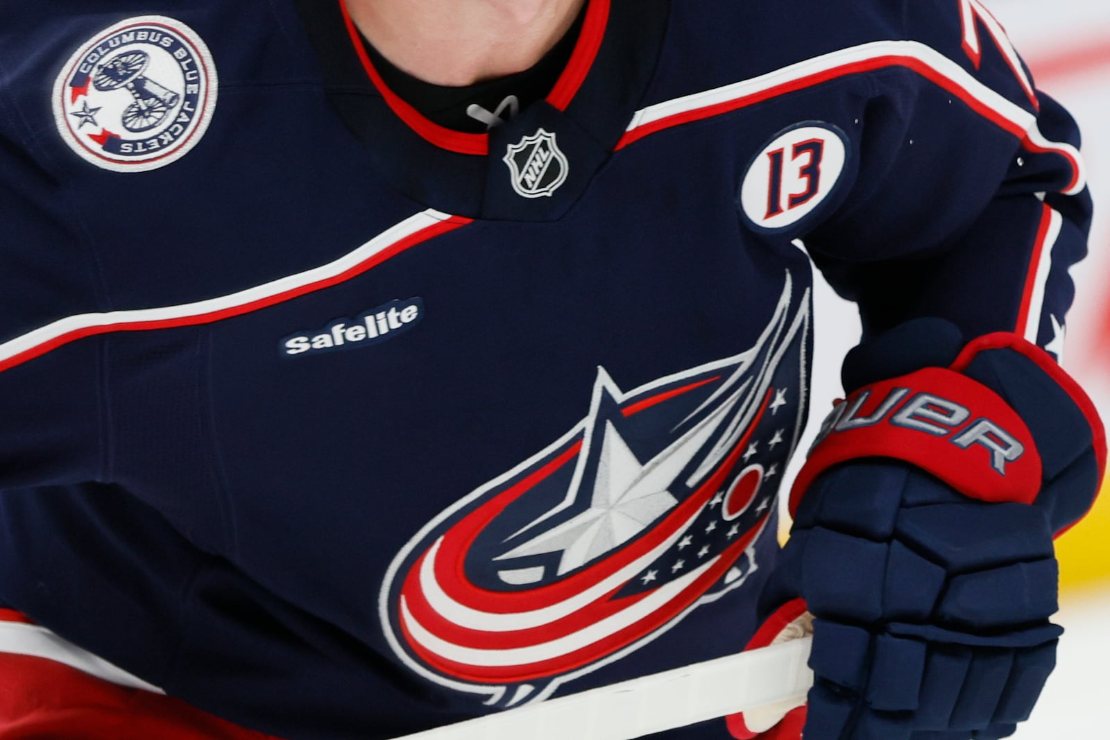 Columbus Blue Jackets players wear helmet stickers and patches honoring Johnny Gaudreau and his brother Matthew during the first period of an NHL hockey game against the Florida Panthers Tuesday, Oct. 15, 2024, in Columbus, Ohio. All teams in the NHL will wear helmet stickers honoring the Gaudreau brothers. (AP Photo/Jay LaPrete)