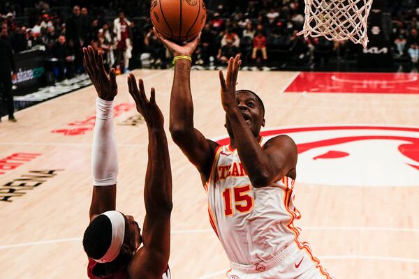 Atlanta Hawks center Clint Capela (15) shoots against Miami Heat center Bam Adebayo (13) during the first half of an NBA basketball game, Monday, Feb. 24, 2025, in Atlanta. (AP Photo/Mike Stewart)