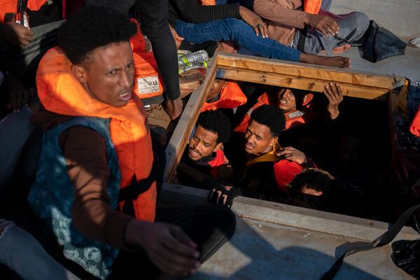 FILE - Migrants from Eritrea, Libya and Sudan crowd the hold of a wooden boat before being assisted by aid workers of the Spanish NGO Open Arms, in the Mediterranean sea, about 30 miles north of Libya, Saturday, June 17, 2023. (AP Photo/Joan Mateu Parra, File)