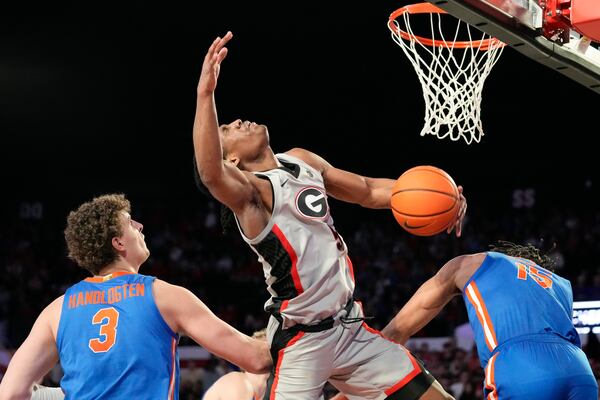 Georgia guard Silas Demary Jr. (5) puts up the ball against Florida guard Alijah Martin (15) during an NCAA college basketball game, Tuesday, Feb. 25, 2025, in Athens, Ga. (AP Photo/Brynn Anderson)