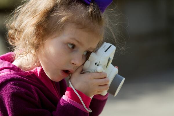 Palmer Livingston, 4, stops to take a photograph on her way to the Atlanta Orchid Society Show at the Atlanta Botanical Garden on Saturday, March 10, 2018. STEVE SCHAEFER / SPECIAL TO THE AJC