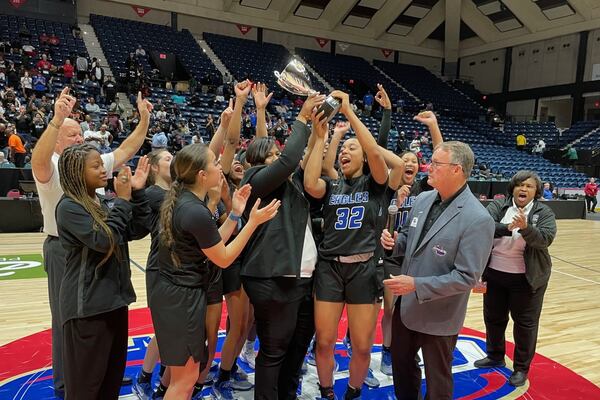 Mount Paran Christian head coach Stephanie Dunn, senior Ciara Alexander (32) and teammates celebrate with the trophy after their 59-52 victory over Josey in the Class 2A girls basketball championship game at the Macon Coliseum on March 7, 2024.