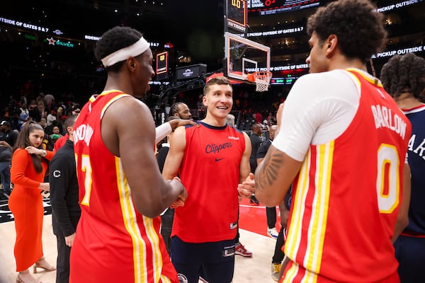 Clippers guard Bogdan Bogdanovic (center) talks with former Hawks teammates Onyeka Okongwu (left) and Dominick Barlow after Friday night's game in Atlanta.