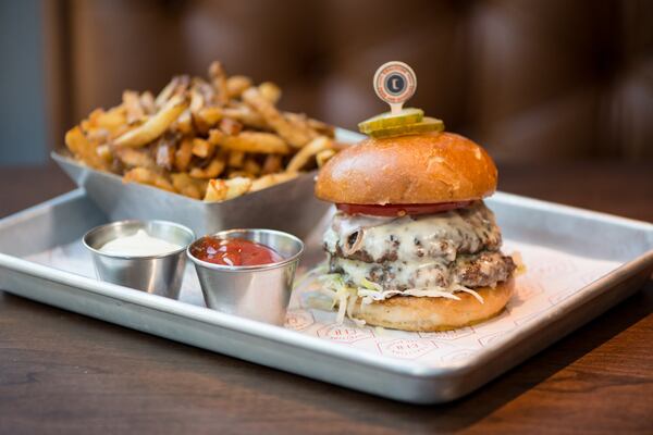 The CFBurger with two beef patties, grilled onion, lettuce, pickles, tomato, and American cheese on a milk bun. Photo credit- Mia Yakel.