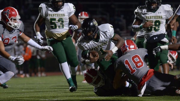  Langston Hughes senior Christian Royalston (1) is tackled at the Buccaneers' end zone at Allatoona High School Friday, Nov. 10, 2017. (Daniel Varnado/For the AJC)