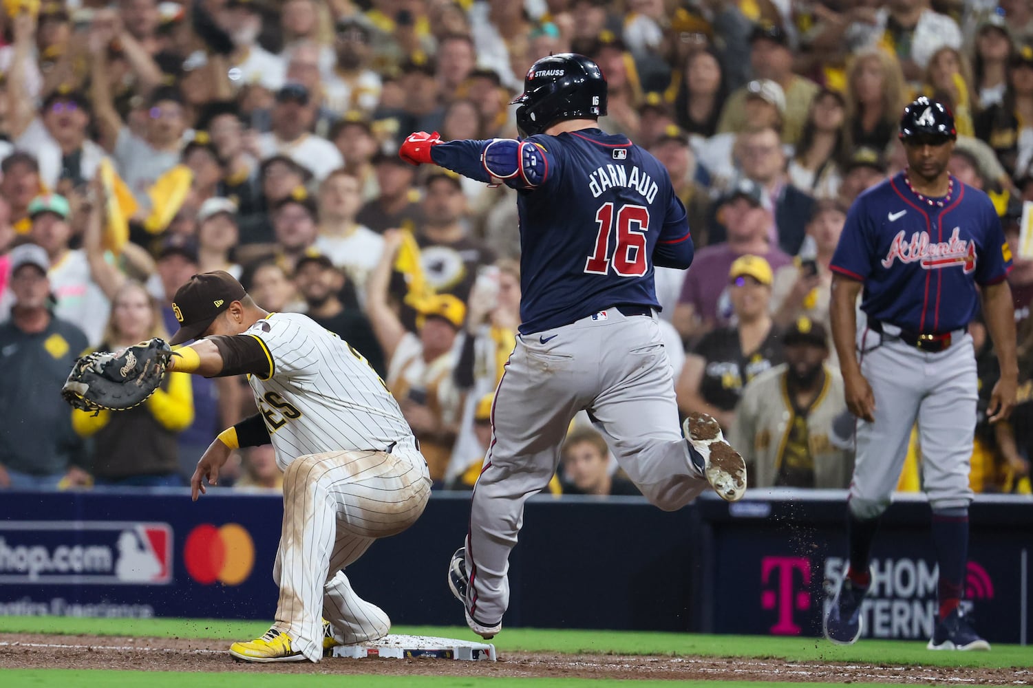 Atlanta Braves catcher Travis d'Arnaud (16) is forced out  by San Diego Padres first baseman Donovan Solano, left, to end the ninth inning of National League Division Series Wild Card Game One at Petco Park in San Diego on Tuesday, Oct. 1, 2024. San Diego won 4-0.   (Jason Getz / Jason.Getz@ajc.com)