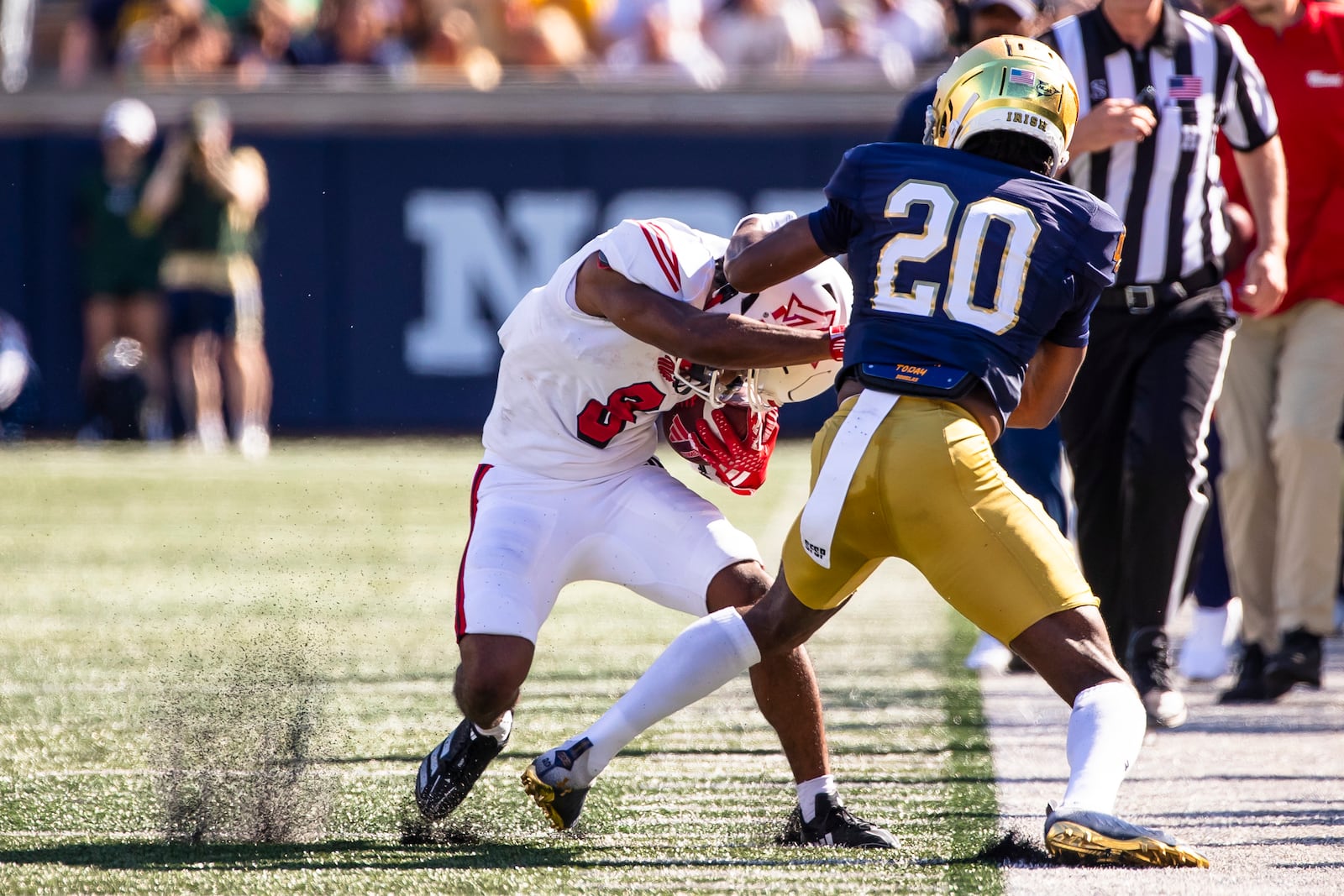 Miami (Ohio) running back Kevin Davis (8) breaks a tackle by Notre Dame defensive back Benjamin Morrison (20) during the first half of an NCAA college football game Saturday, Sept. 21, 2024, in South Bend, Ind. (AP Photo/Michael Caterina)