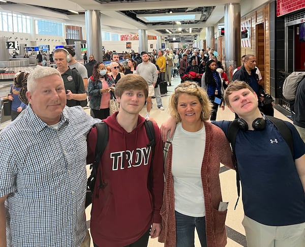 Mark, Andrew, Jodi and Lucas Wells got to the Hartsfield-Jackson Atlanta International Airport later than they planned on Dec. 26 -- and with security lines stretching to the airport lobby, they weren't sure they were going to make their flight to California. Airlines were recommending travelers get to the airport two-and-a-half to three hours early. (Photo by Cassidy Alexander)