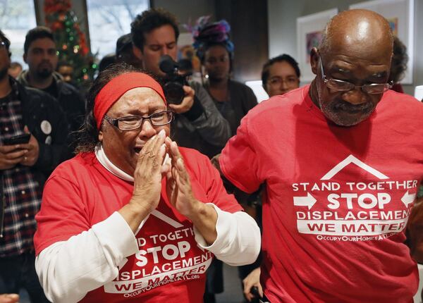 Bertha Darden, standing with her husband, Robert, becomes emotional as she talks with Rashad Taylor (not pictured), a senior adviser to Atlanta Mayor Keisha Lance Bottoms, as the Dardens joined others in occupying the reception area of the mayor’s office on December 16, 2019. The protesters want the mayor to ensure residents of Atlanta’s Peoplestown community get to stay in their homes and not be displaced by eminent domain to build a park and retention pond. (Bob Andres / bandres@ajc.com)