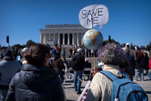 Demonstrators gather for the Stand Up For Science rally near the Lincoln Memorial, Friday, March 7, 2025, in Washington. (AP Photo/Mark Schiefelbein)