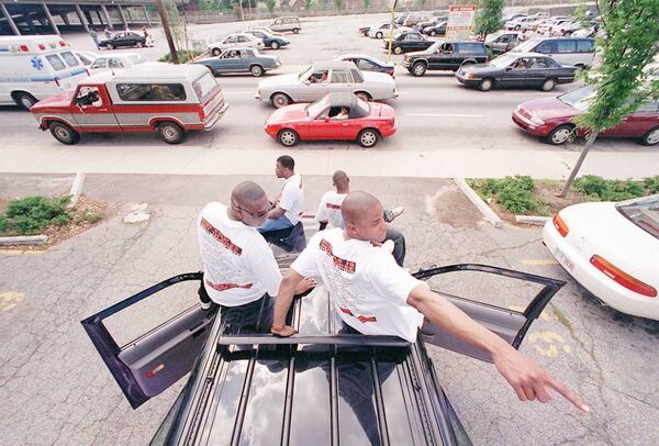 James Tate 18 right of Detroit points out some activity behind him to his friend Modd Washington 21 as the group plays music and watches the Freaknik traffic creep by on Spring Street near The Varsity restaurant on Friday Also on the truck in front are Demetrius Danforth 24 left and Meadstro Washington 24 All are from Detroit