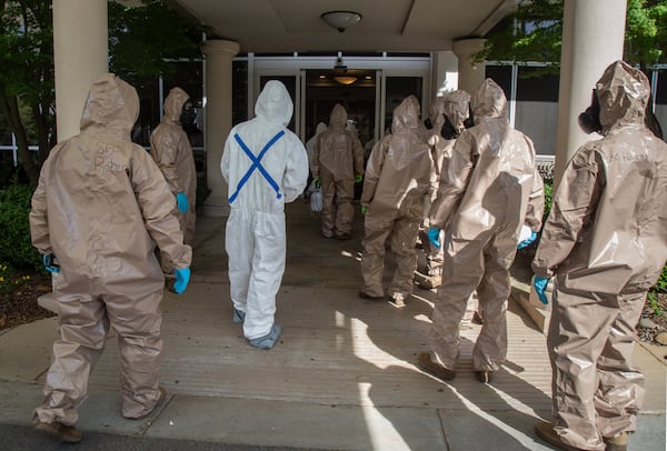 The 265th Infectious Control GA Army National Guard enters the Canterbury Court, a senior living facility in Buckhead, to disinfect the building on Friday, April 10, 2020. (STEVE SCHAEFER / Special to the AJC)