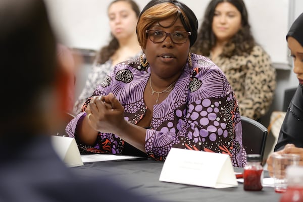 Small business owner Ada Made Diakite from Ivory Coast in West Africa speaks during an event celebrating the two-year anniversary of the International Rescue Committee's Community Navigator Pilot Program at IRC headquarters on Friday, June 23, 2023. The federally funded program was created to assist immigrants and refugees with tools to grow their small businesses. (Natrice Miller/natrice.miller@ajc.com)