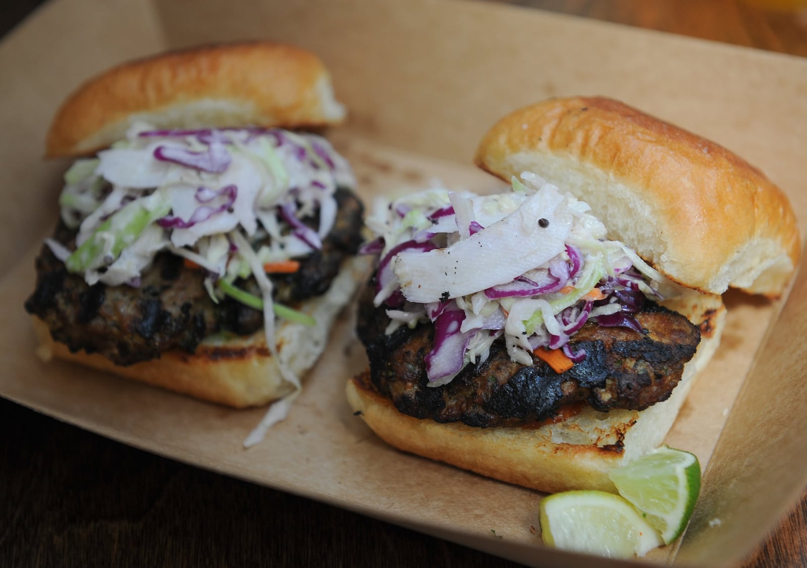 Botiwalla Lamb Burgers are ground lamb sliders seasoned with cumin, ginger, chillies, mint and cilantro. Served with desi slaw, green chutney and Maggi ketchup on toasted buns brushed with ghee. (Beckysteinphotography.com)