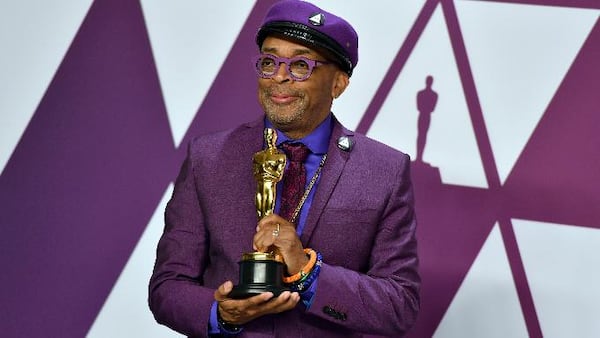 Spike Lee poses with the award for best adapted screenplay for "BlacKkKlansman" in the press room at the Oscars on Sunday, Feb. 24, 2019, at the Dolby Theatre in Los Angeles.