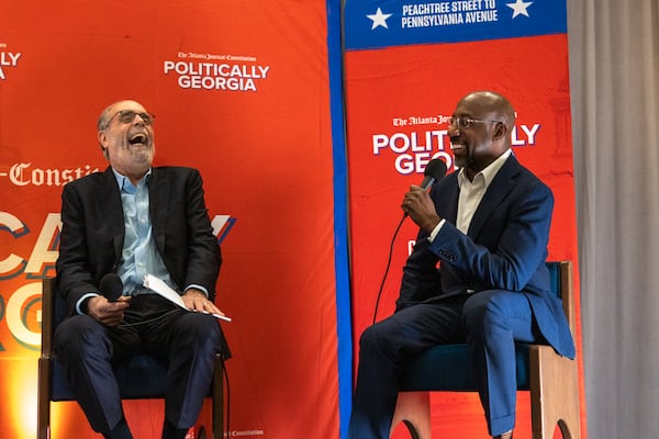 Bill Nigut (left) enjoys a lighthearted moment with U.S. Sen. Raphael Warnock at a Politically Georgia event in Savannah.