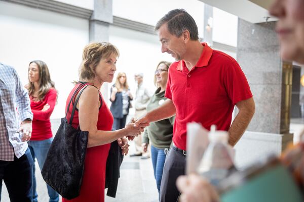 Republican Jason Frazier (right) shakes the hand of supporter Anne Delmas after the public comment portion of the Fulton County Board of Commissioners meeting in Atlanta on Wednesday, June 7, 2023. The board is voted down his  nomination. (Arvin Temkar/The Atlanta Journal-Constitution)