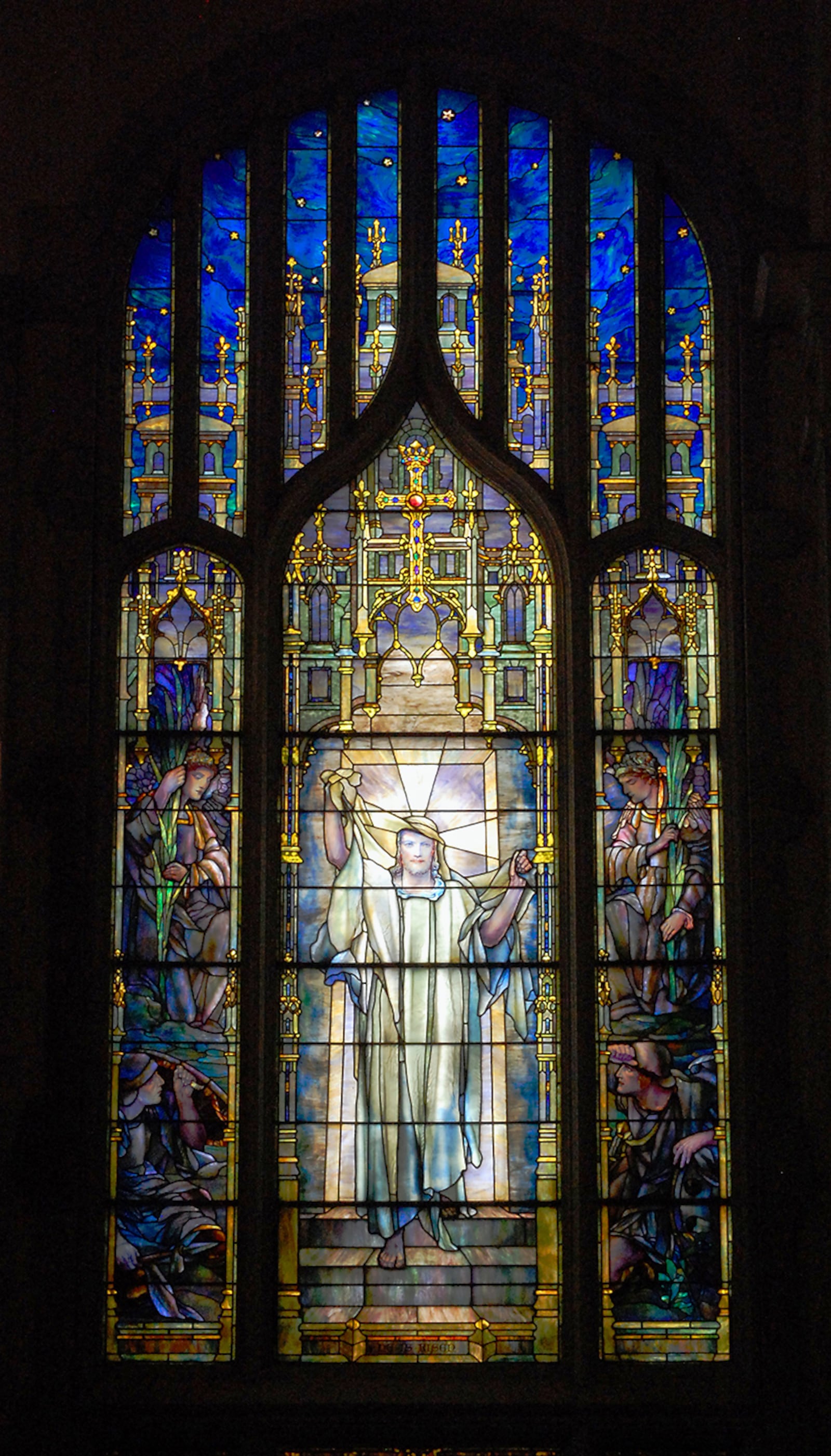 The "Resurrection" window at First Presbyterian Church of Atlanta is by Tiffany and was the first one installed at the church. It shows Jesus walking out of the tomb. On the left and right panels, Roman soldiers cower and disciples bear flowers.